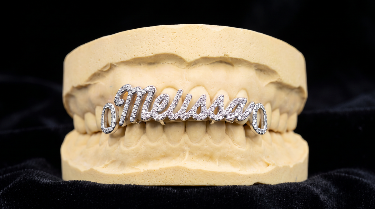 Custom name grillz in script lettering set with diamonds on dental mold