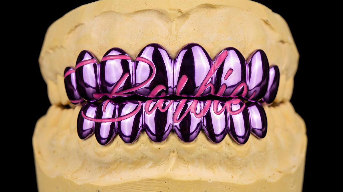 Barbie grillz with purple chrome teeth and pink script lettering on dental mold